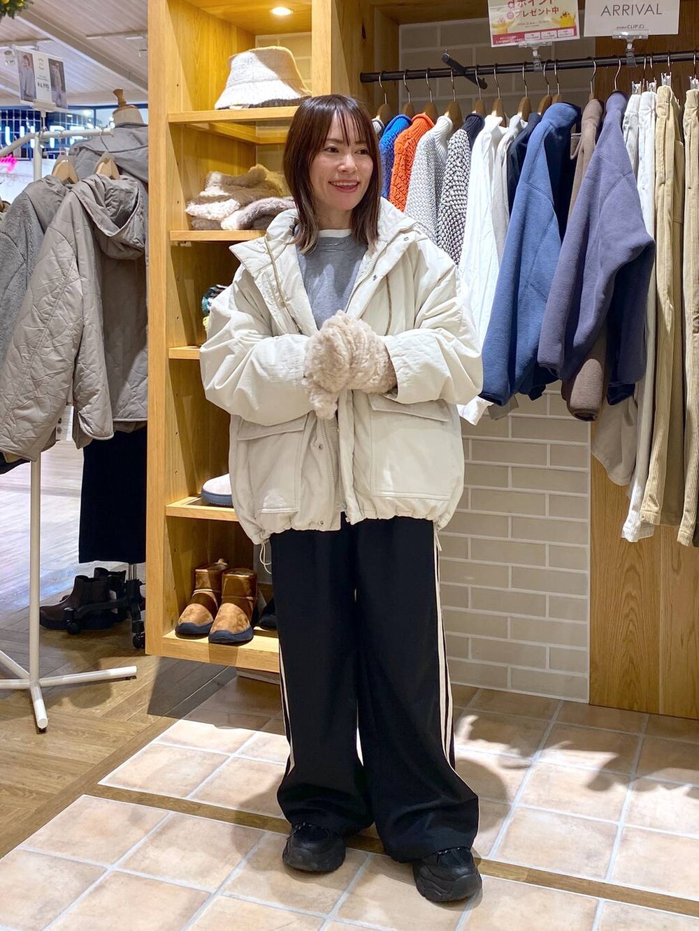 ベージュ系のブルゾン、グレー系のニット/セーター、ホワイト系のTシャツ/カットソーを着用したレディースの冬コーディネートの3枚目の写真