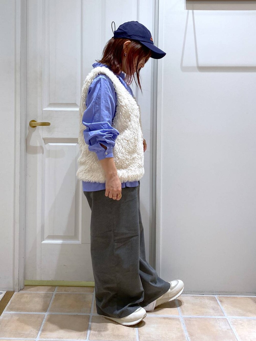 ブルー系のシャツ/ブラウス、グレー系のその他パンツ、ベージュ系のベストを着用したレディースの秋コーディネートの5枚目の写真