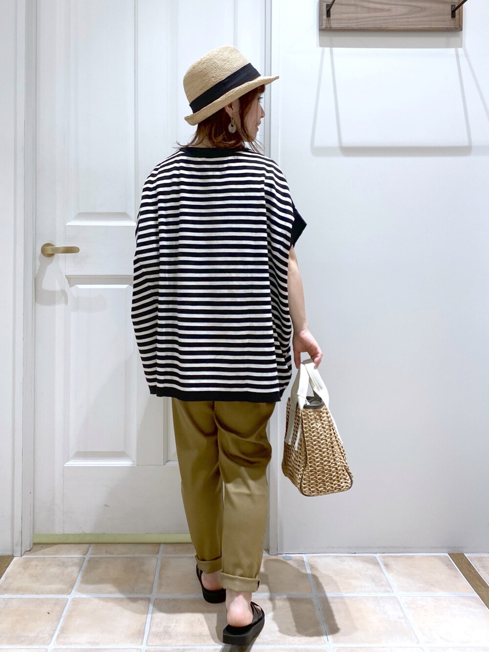 ブラック系のニット/セーター、ブラウン系のショルダーバッグ、ブラウン系のその他パンツを着用したレディースの春コーディネートの4枚目の写真