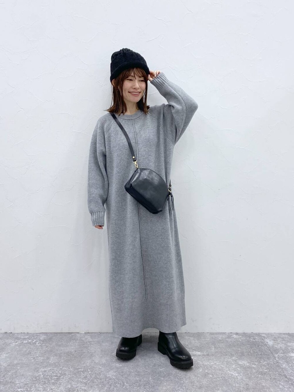 グレー系のワンピース、ブラック系のニットキャップ/ビーニーを着用したレディースの秋コーディネートの3枚目の写真