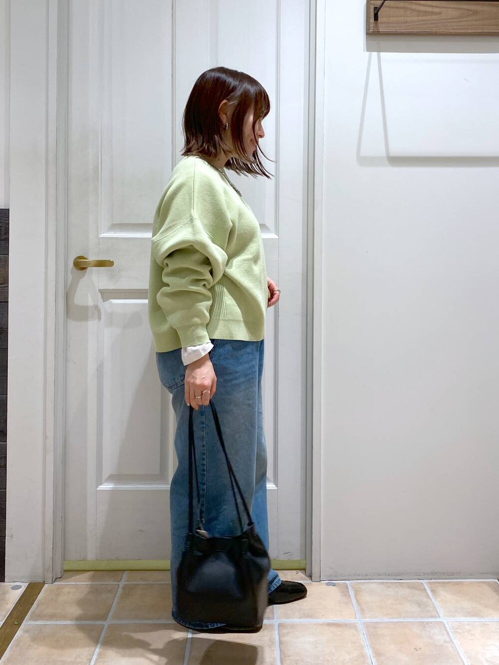 ブラック系のローファー、ブルー系のデニムパンツ、ホワイト系のTシャツ/カットソーを着用したレディースの春コーディネートの4枚目の写真