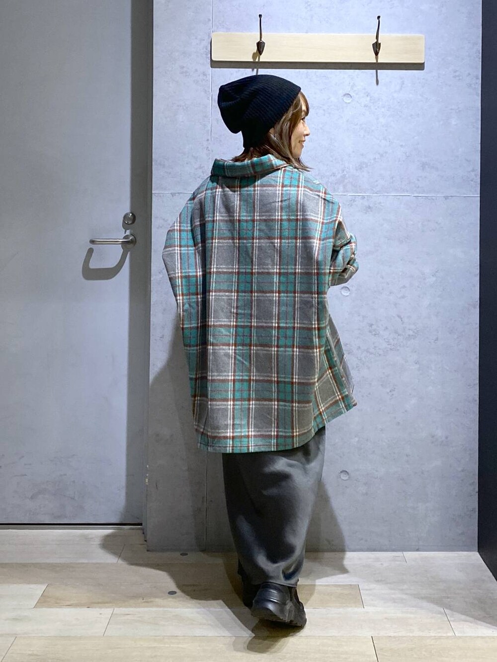 グレー系のスカート、ブラック系のスニーカー、グレー系のシャツ/ブラウスを着用したレディースの秋コーディネートの5枚目の写真