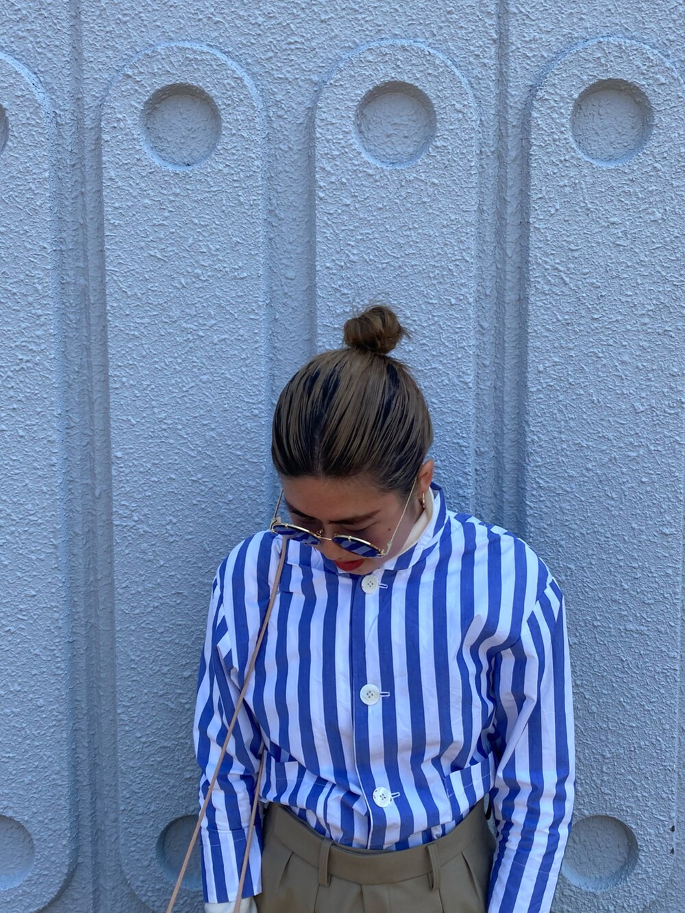 ブルー系のテーラードジャケット、ホワイト系のスニーカーを着用したレディースの春コーディネートの3枚目の写真