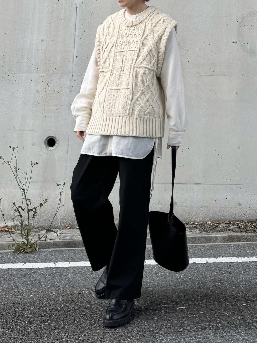 ホワイト系のシャツ/ブラウス、ベージュ系のニット/セーター、ブラック系のローファーを着用したレディースの春コーディネートの3枚目の写真