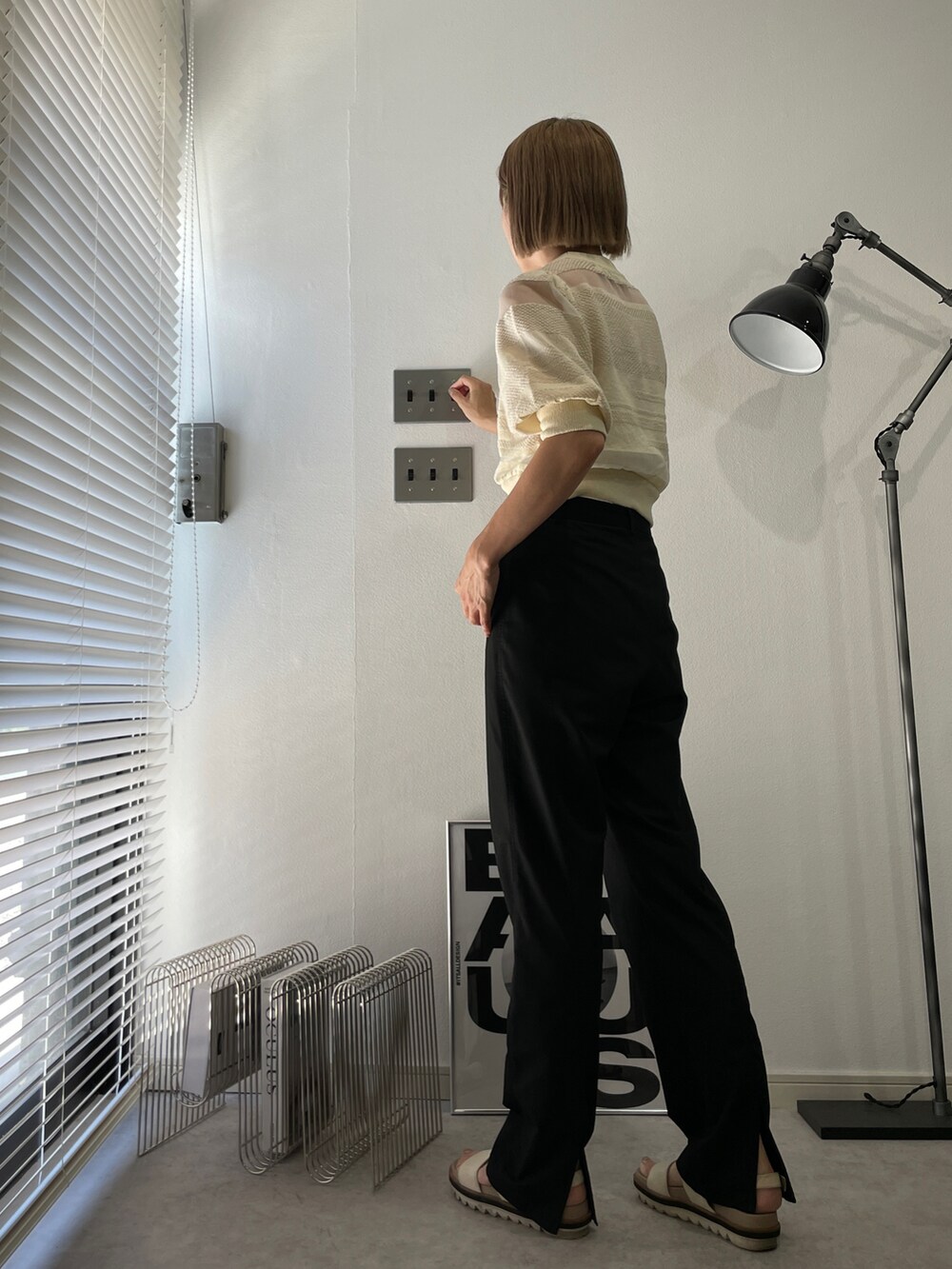 ホワイト系のニット/セーター、ブラック系のパンツ、ホワイト系のサンダルを着用したレディースの夏コーディネートの2枚目の写真