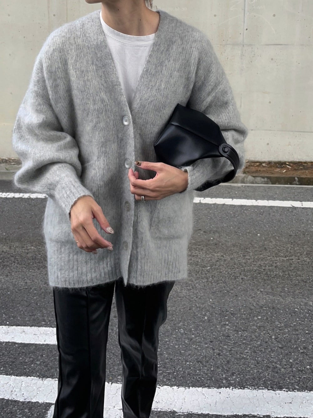 グレー系のカーディガン/ボレロ、ブラック系のスラックス、ブラック系のバッグを着用したレディースの秋コーディネートの2枚目の写真