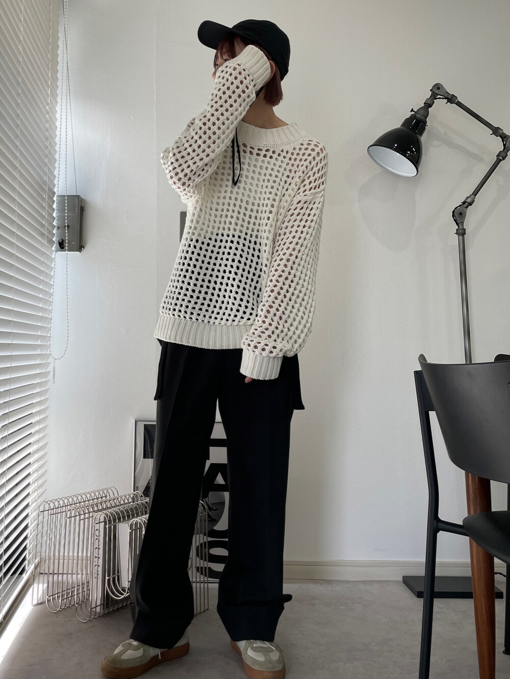 グレー系のその他パンツ、ホワイト系のニット/セーター、ホワイト系のスニーカーを着用したレディースの秋コーディネートの2枚目の写真
