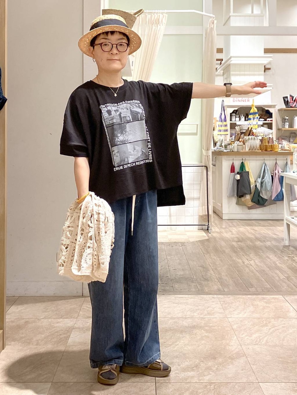 その他のサンダル、ベージュ系のベスト、ブルー系のデニムパンツを着用したレディースの夏コーディネートの3枚目の写真