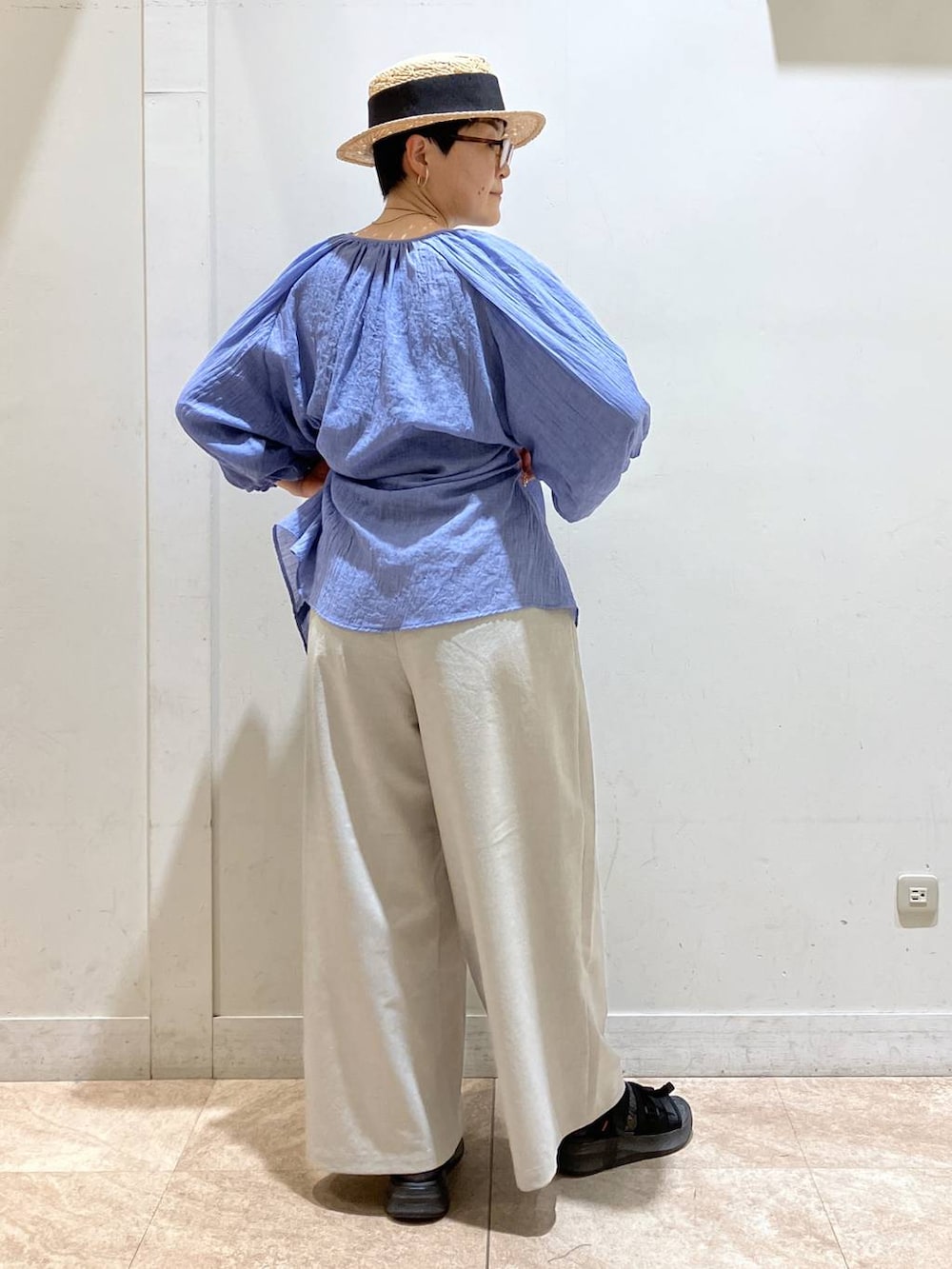 グレー系のその他パンツ、ブルー系のチュニック、シルバー系のイヤーカフを着用したレディースの夏コーディネートの4枚目の写真