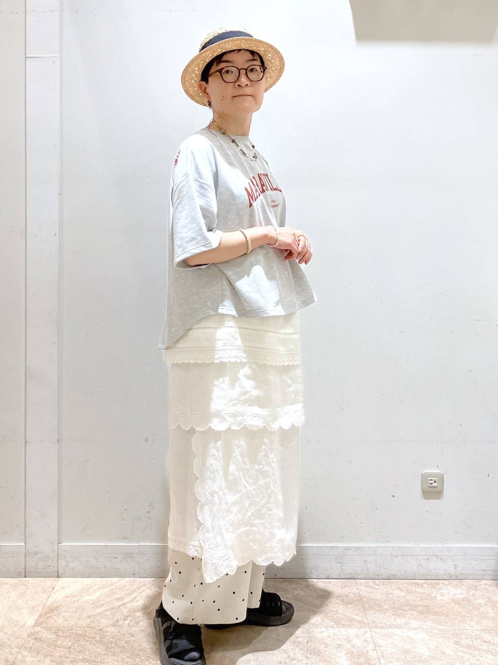 ホワイト系のスカート、グレー系のTシャツ/カットソー、シルバー系のイヤーカフを着用したレディースの春コーディネートの4枚目の写真