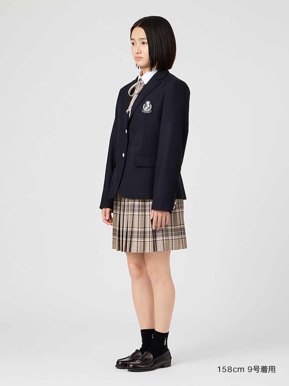 ブラウン系のローファー、ホワイト系のシャツ/ブラウス、ブラウン系のスカートを着用したレディースの冬コーディネートの2枚目の写真