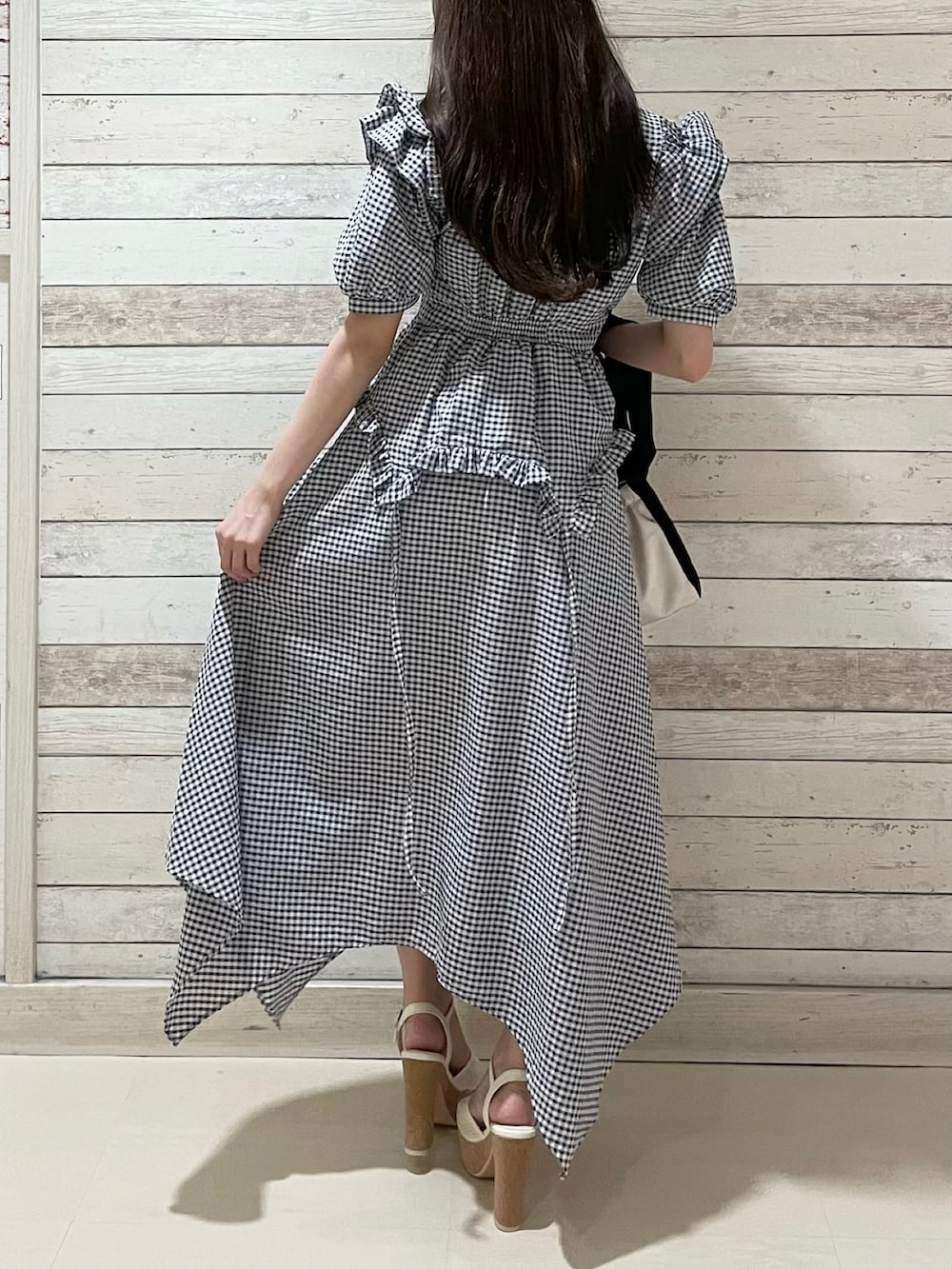 その他のワンピース、ホワイト系のハンドバッグ、ホワイト系のサンダルを着用したレディースの夏コーディネートの3枚目の写真