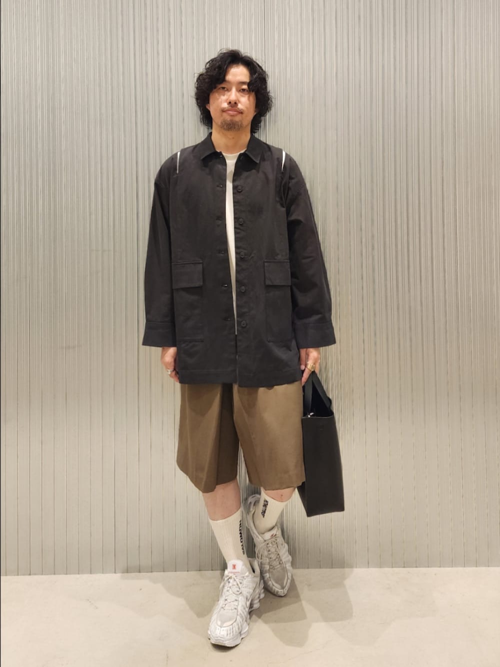 ブラック系のハンドバッグ、ブラウン系のその他パンツ、ブラック系のカバーオールを着用したメンズの夏コーディネートの2枚目の写真