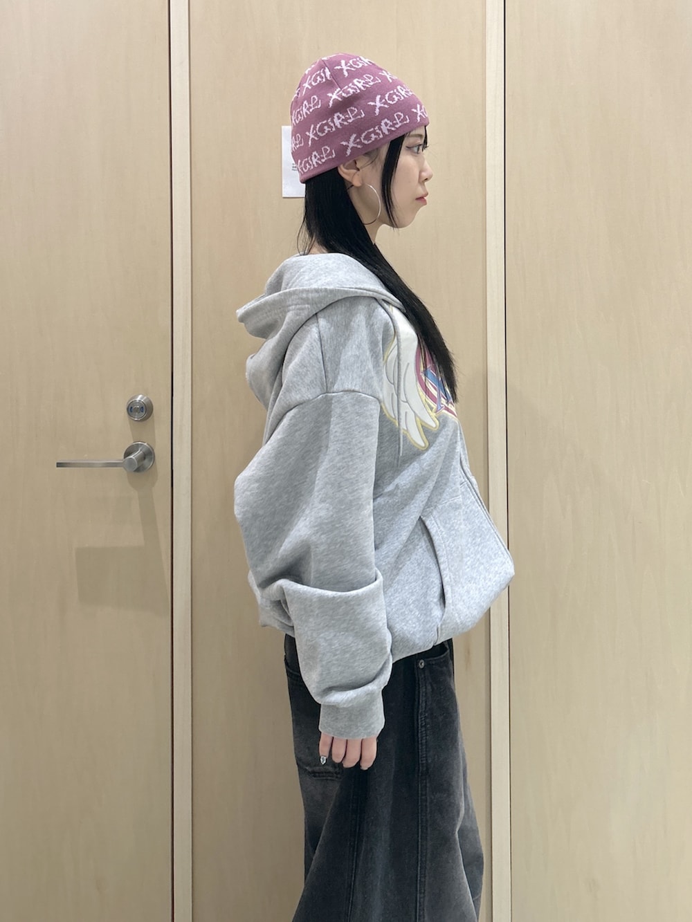 グレー系のパーカー、ブラック系のデニムパンツ、ブラック系のバックパック/リュックを着用したレディースの冬コーディネートの5枚目の写真