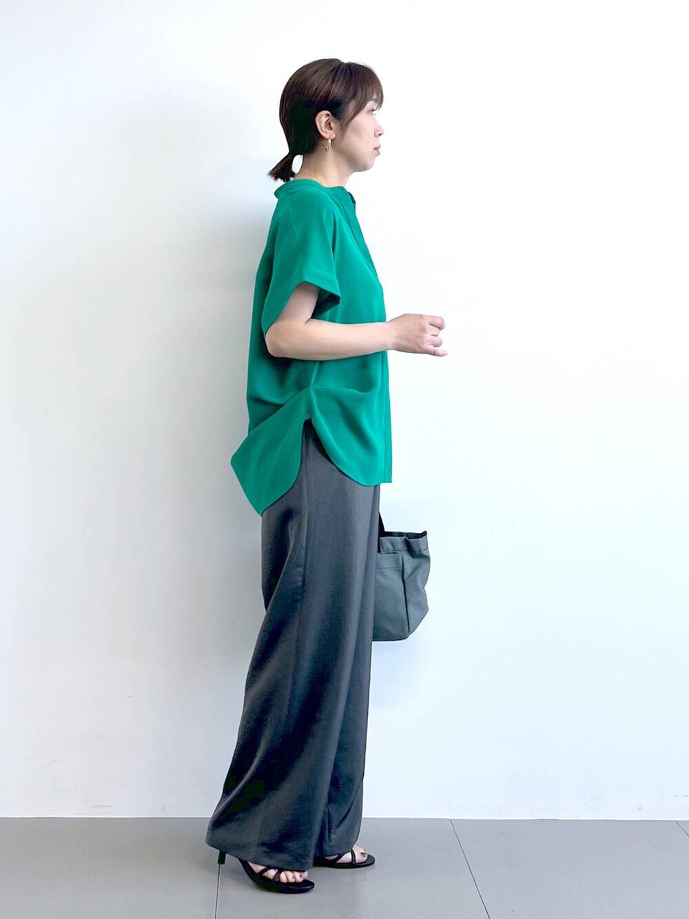 グレー系のその他パンツ、ブラック系のサンダル、ブラック系のショルダーバッグを着用したレディースの春コーディネートの6枚目の写真