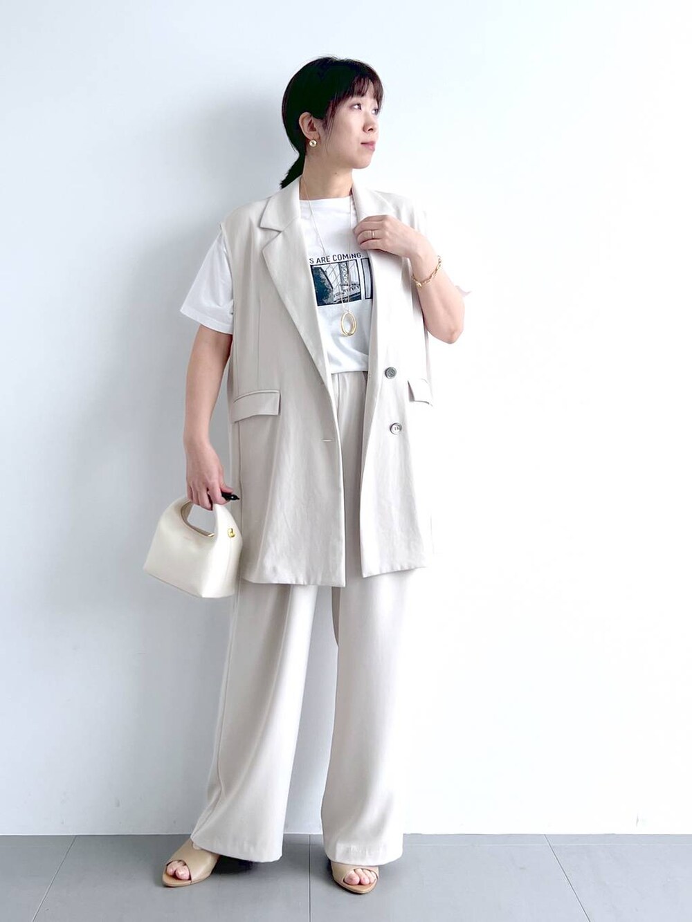 ホワイト系のベスト、ホワイト系のその他パンツ、ホワイト系のTシャツ/カットソーを着用したレディースの春コーディネートの5枚目の写真