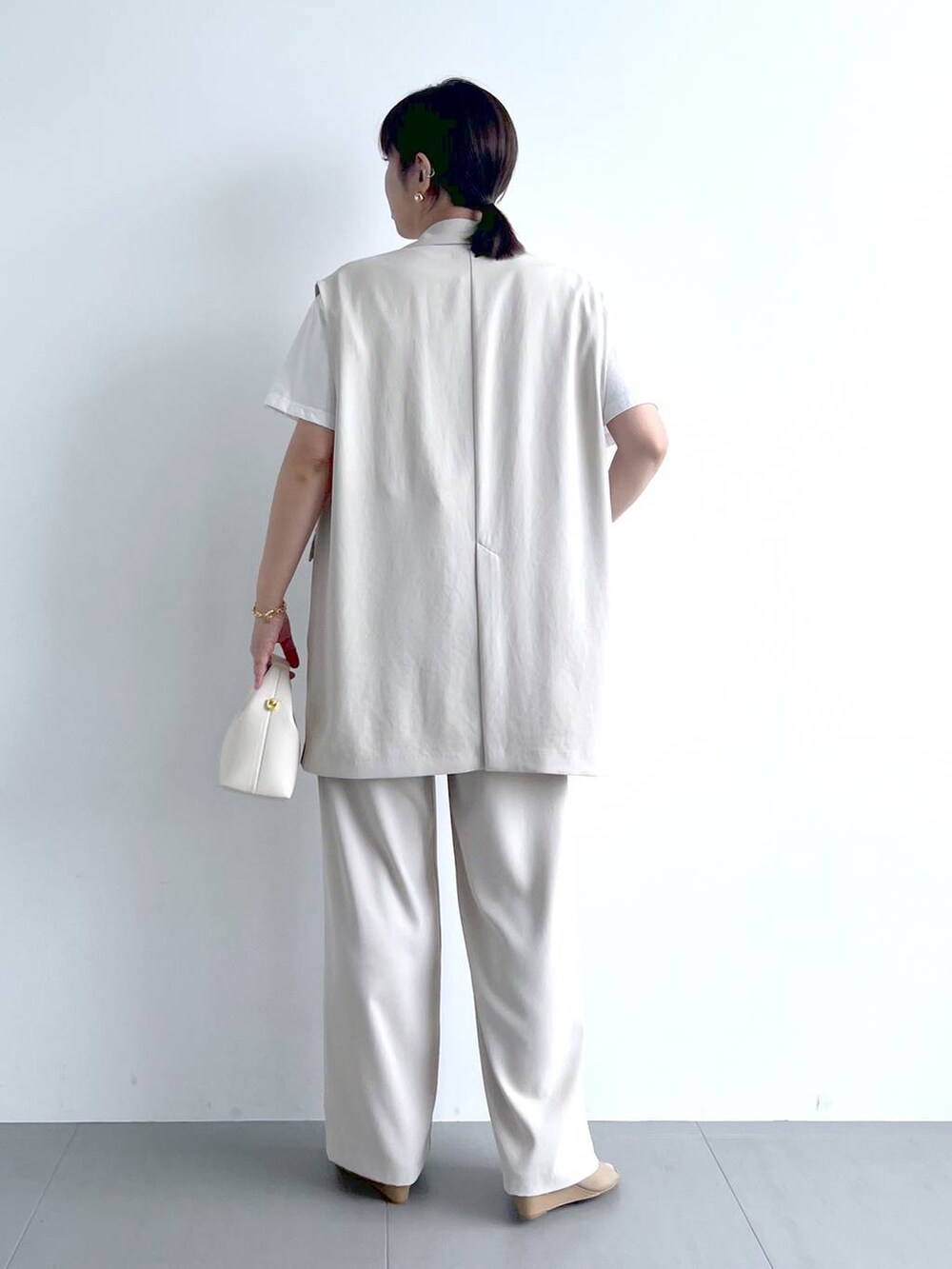 ホワイト系のベスト、ホワイト系のその他パンツ、ホワイト系のTシャツ/カットソーを着用したレディースの春コーディネートの9枚目の写真