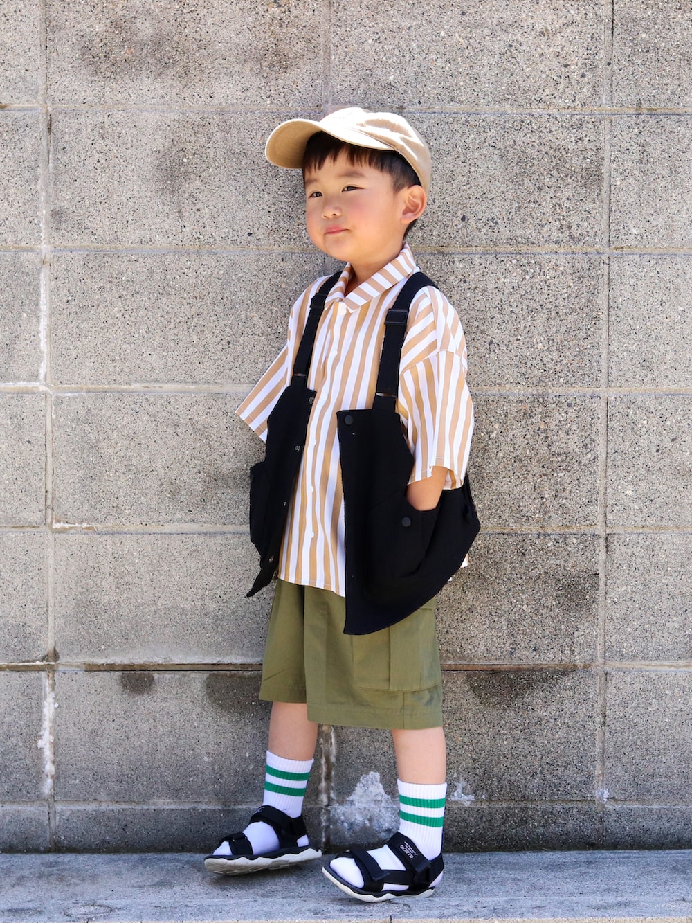 ベージュ系のシャツ/ブラウス、ブラック系のベスト、グリーン系のその他パンツを着用したキッズの春コーディネートの2枚目の写真