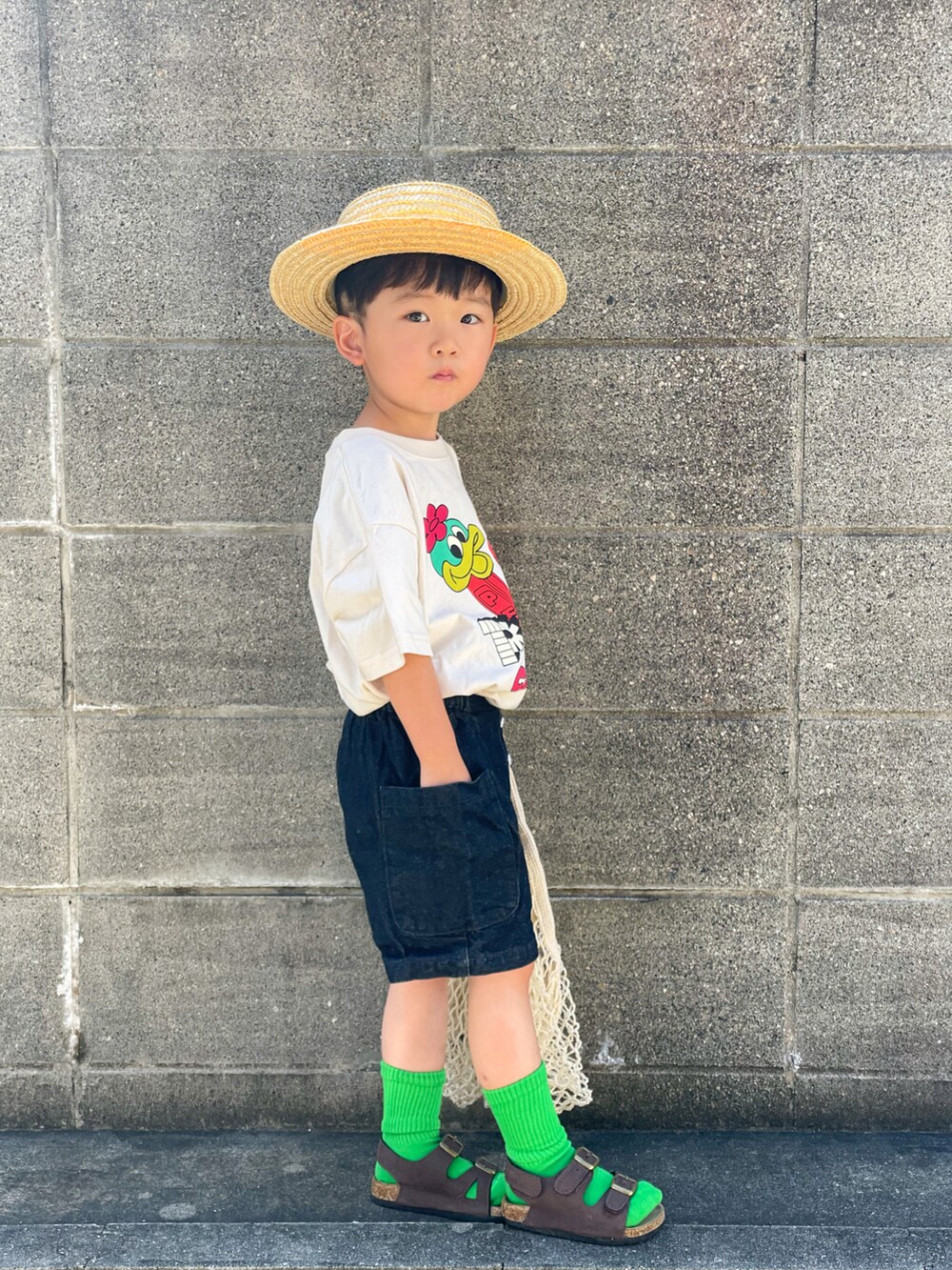 ホワイト系のTシャツ/カットソー、ブルー系のデニムパンツ、ブラウン系のサンダルを着用したキッズの夏コーディネートの4枚目の写真