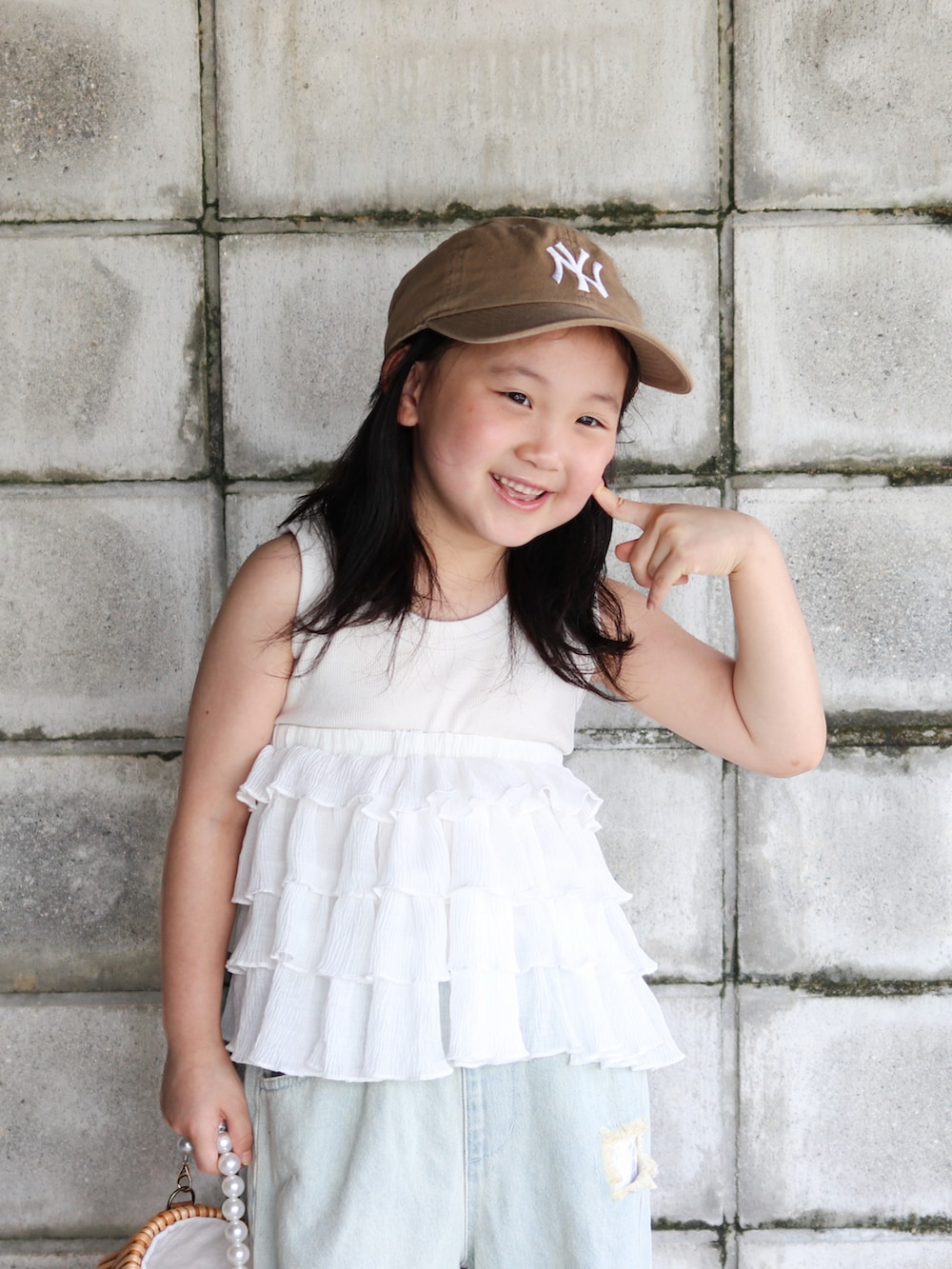 ブルー系のデニムパンツ、その他のかごバッグ、ベージュ系のサンダルを着用したキッズの夏コーディネートの4枚目の写真