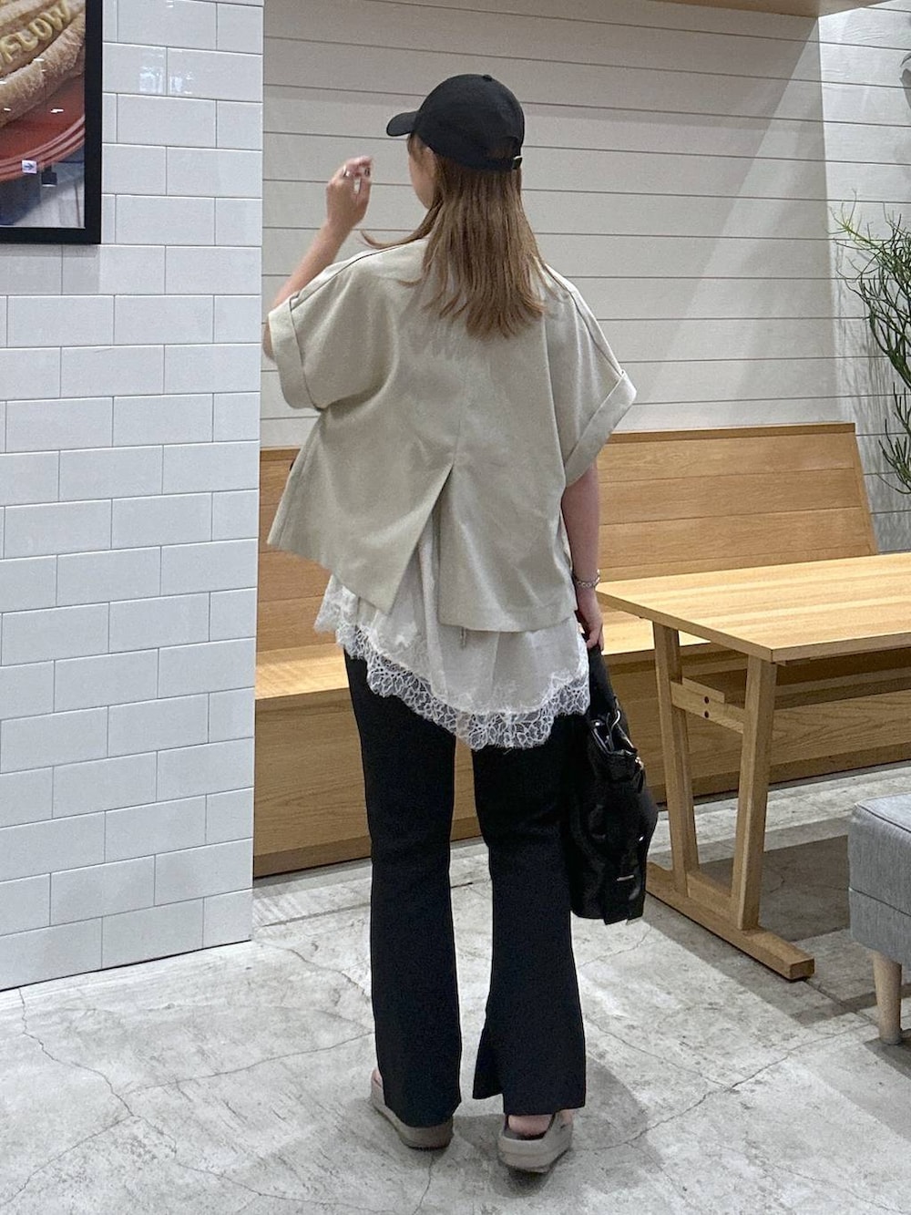ブラック系のトートバッグ、ブラック系のその他パンツ、ベージュ系のキャミソールを着用したレディースの夏コーディネートの3枚目の写真