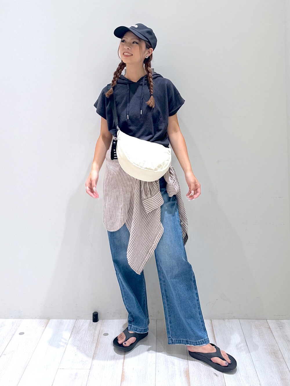 ベージュ系のサンダル、ブルー系のデニムパンツ、グレー系のTシャツ/カットソーを着用したレディースの夏コーディネートの2枚目の写真