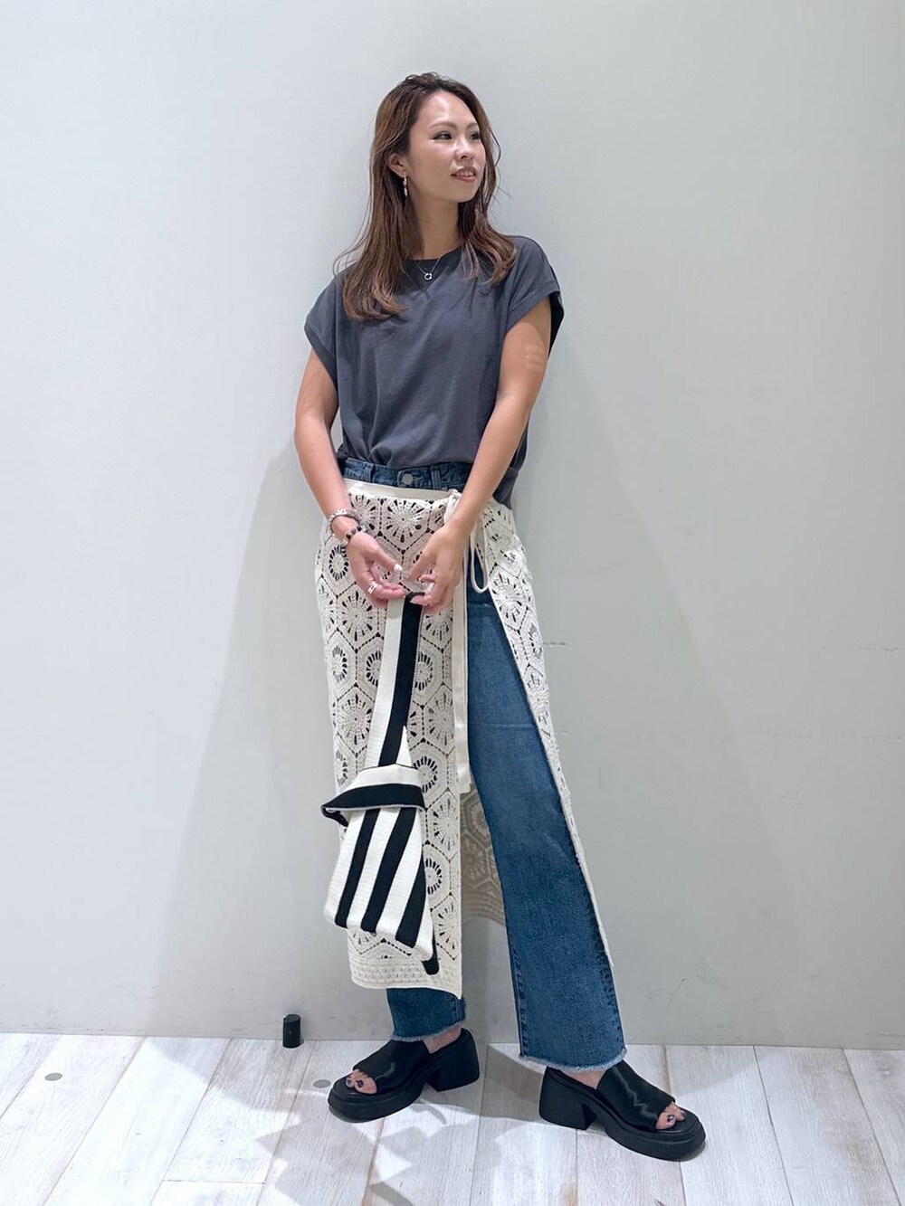 ブラック系のサンダル、ホワイト系のスカート、ホワイト系のエコバッグ/サブバッグを着用したレディースの秋コーディネートの2枚目の写真