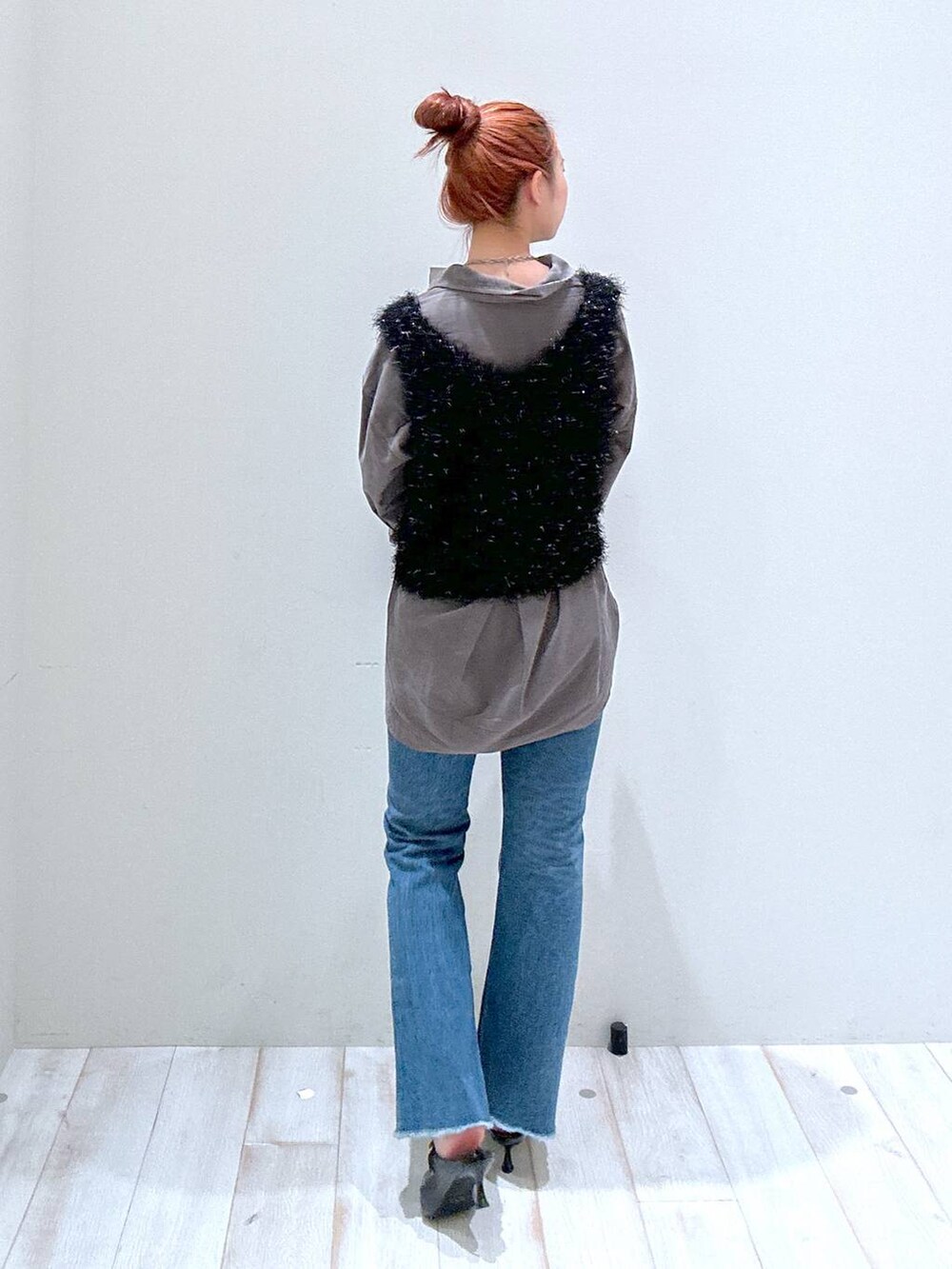 ブラック系のショルダーバッグ、ブルー系のデニムパンツ、グレー系のシャツ/ブラウスを着用したレディースの秋コーディネートの3枚目の写真