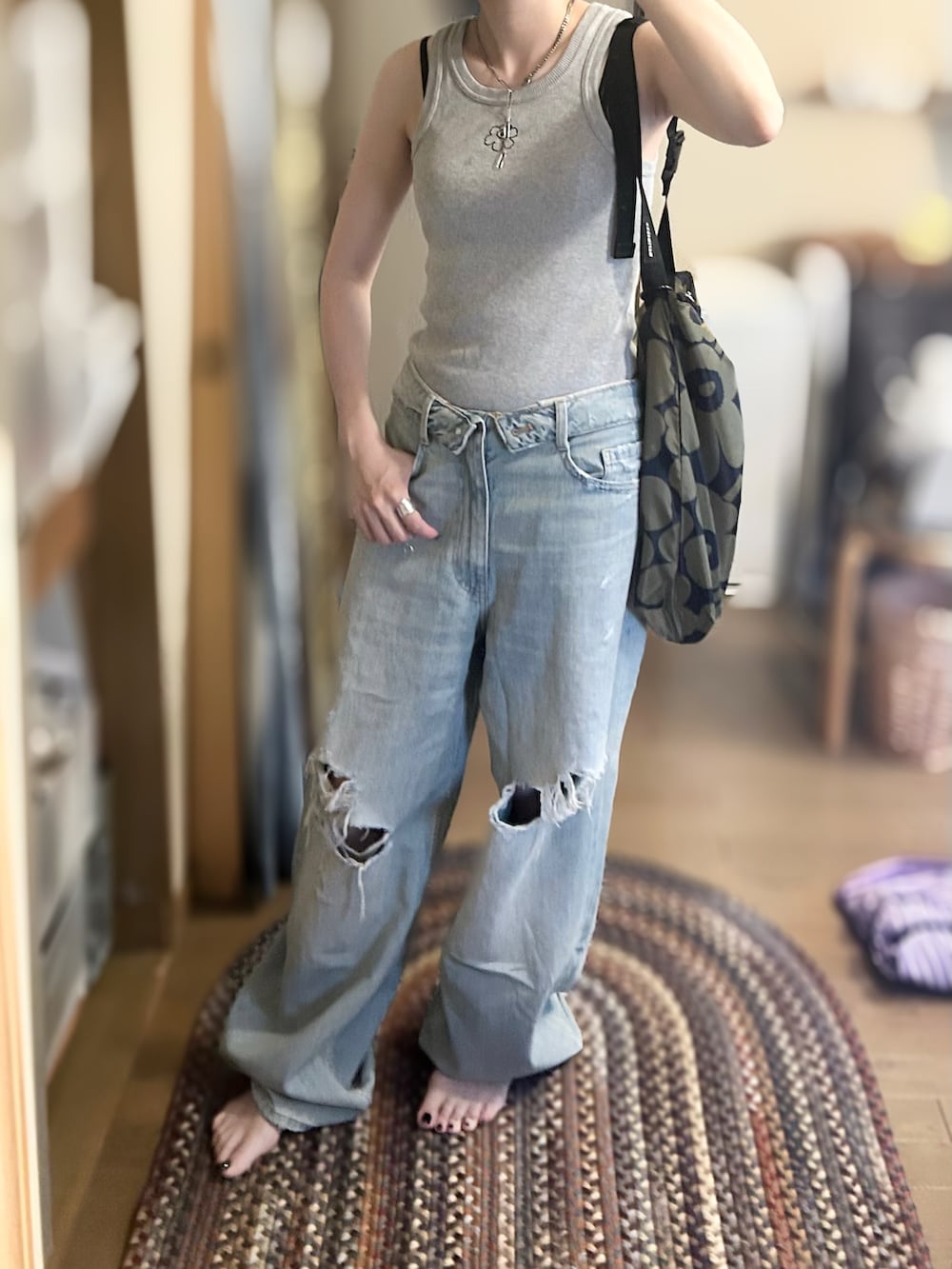 グレー系のタンクトップ、パープル系のシャツ/ブラウス、ブルー系のデニムパンツを着用したレディースの夏コーディネートの2枚目の写真