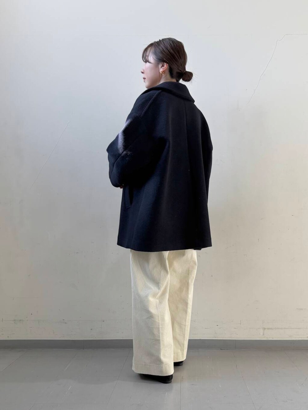 ブラック系のローファー、ブルー系のその他アウター、ホワイト系のその他パンツを着用したレディースの冬コーディネートの2枚目の写真