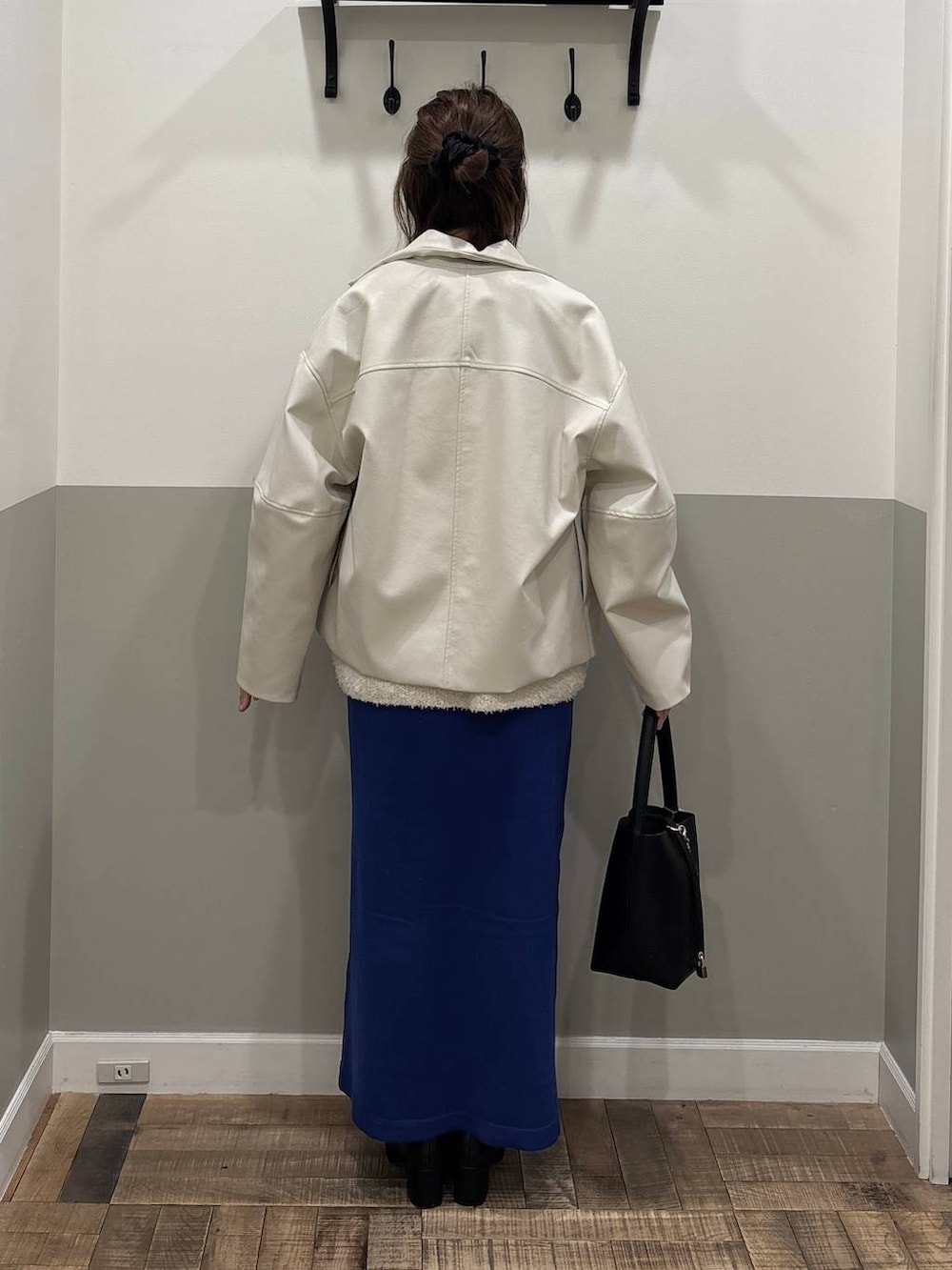 ブラック系のブーツ、ブルー系のワンピース、ホワイト系のブルゾンを着用したレディースの冬コーディネートの4枚目の写真