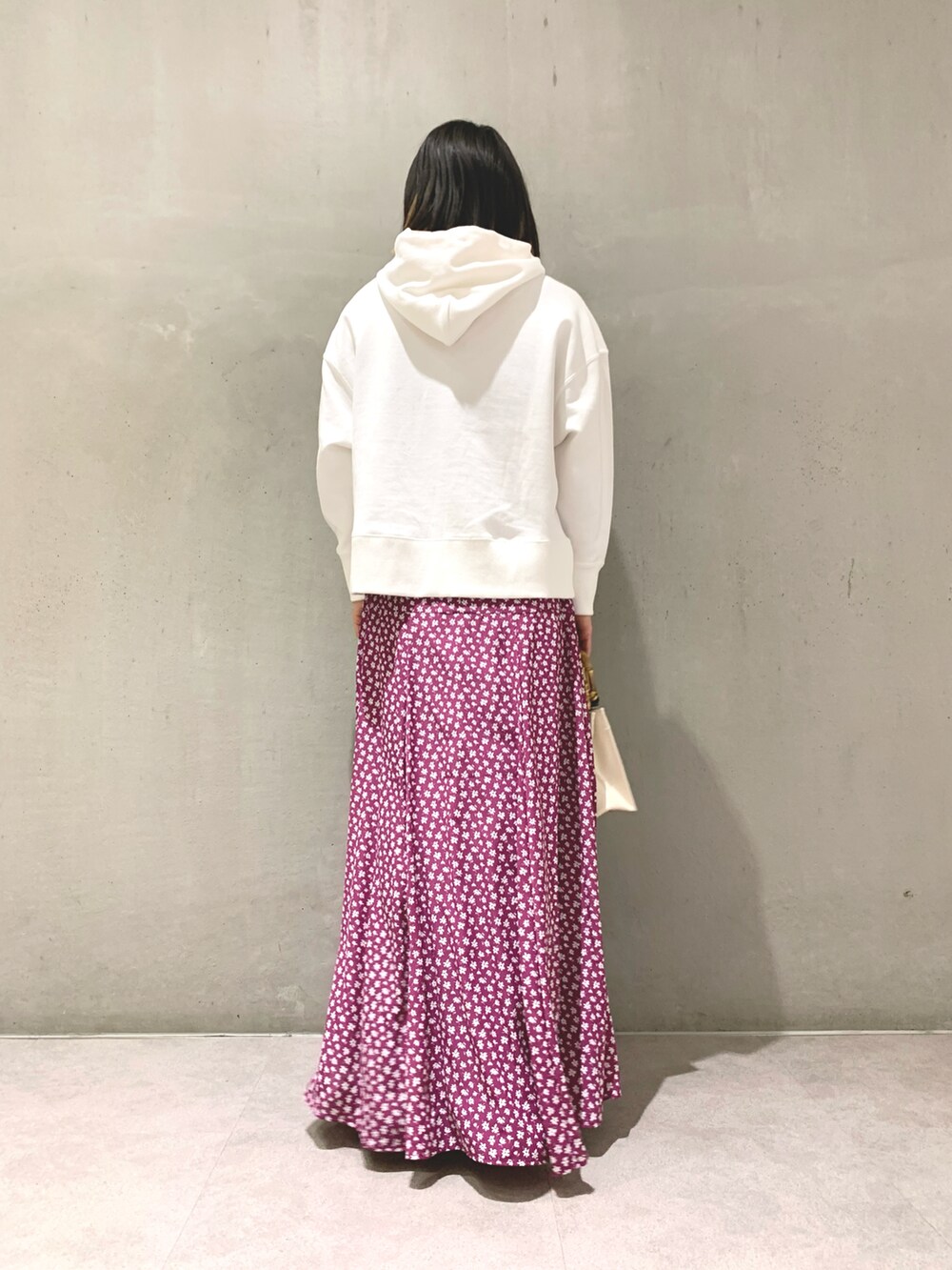 ホワイト系のTシャツ/カットソー、パープル系のスカート、イエロー系のハンドバッグを着用したレディースの冬コーディネートの2枚目の写真