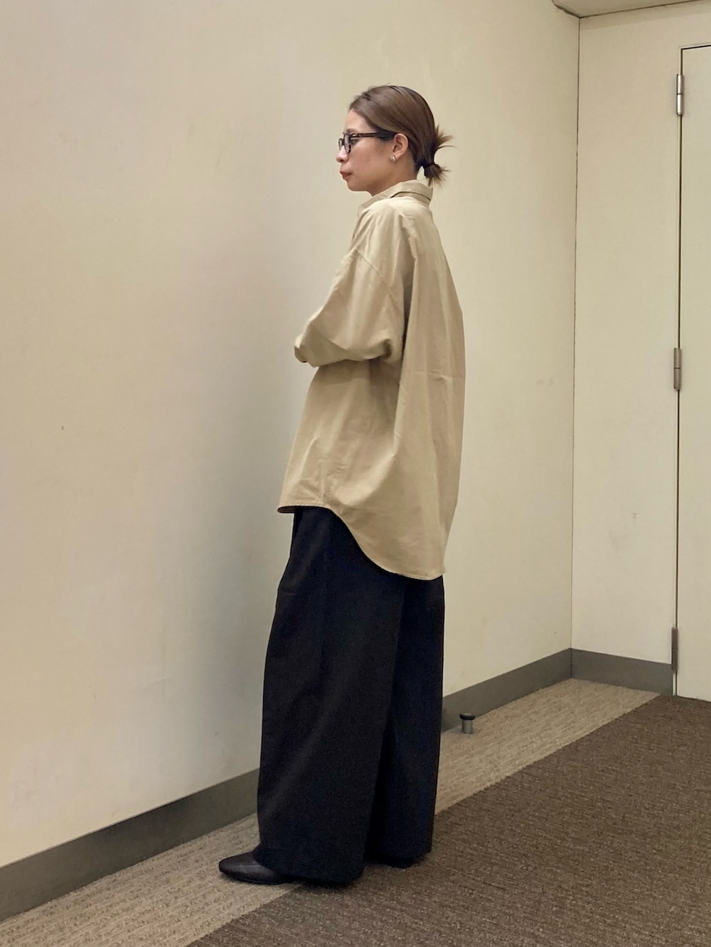 ブラウン系のパンプス、ブラック系のショルダーバッグ、ホワイト系のTシャツ/カットソーを着用したレディースの秋コーディネートの3枚目の写真