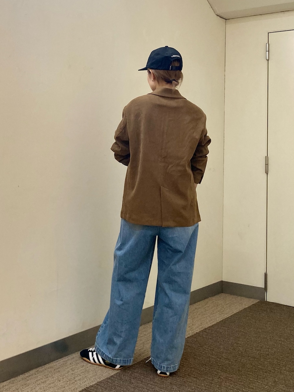 ホワイト系のTシャツ/カットソー、ベージュ系のその他アウター、ブルー系のデニムパンツを着用したレディースの秋コーディネートの4枚目の写真