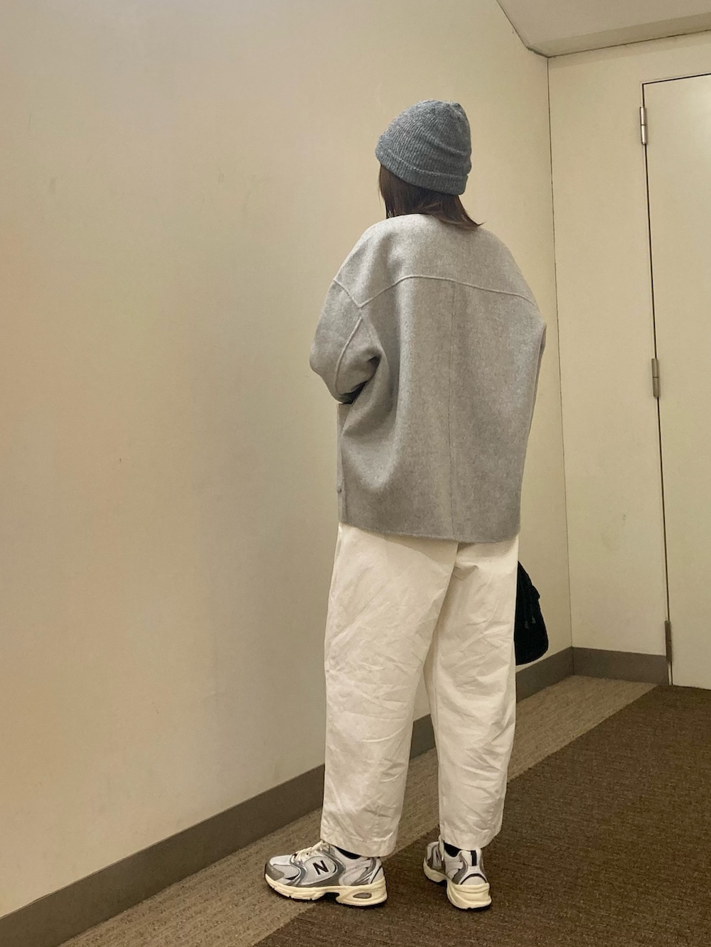 グレー系のその他アウター、ホワイト系のTシャツ/カットソー、シルバー系のスニーカーを着用したレディースの秋コーディネートの3枚目の写真