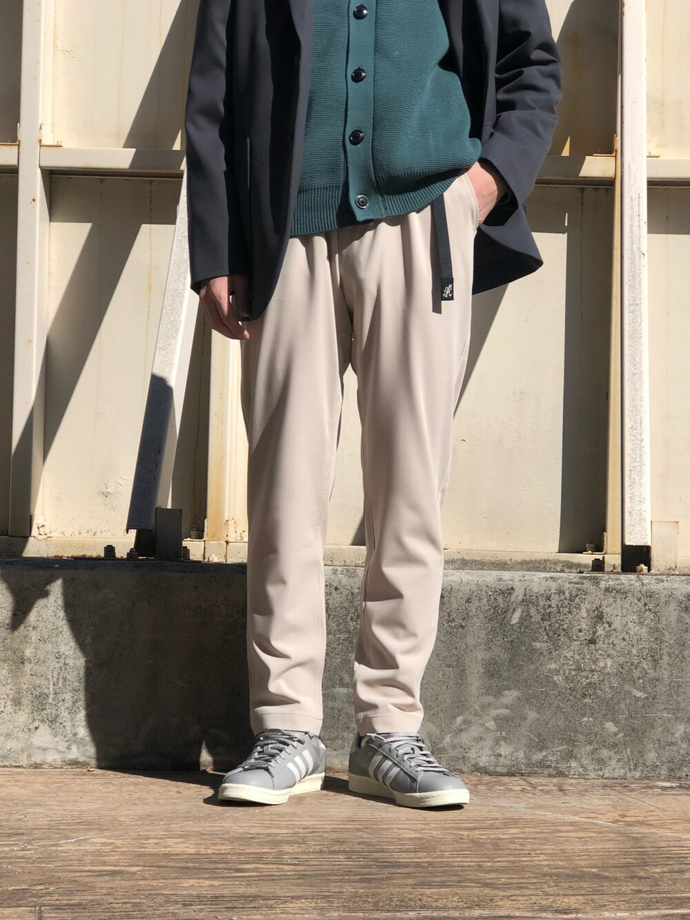 グレー系のその他アウター、グリーン系のカーディガン/ボレロ、グレー系のスニーカーを着用したメンズの冬コーディネートの3枚目の写真