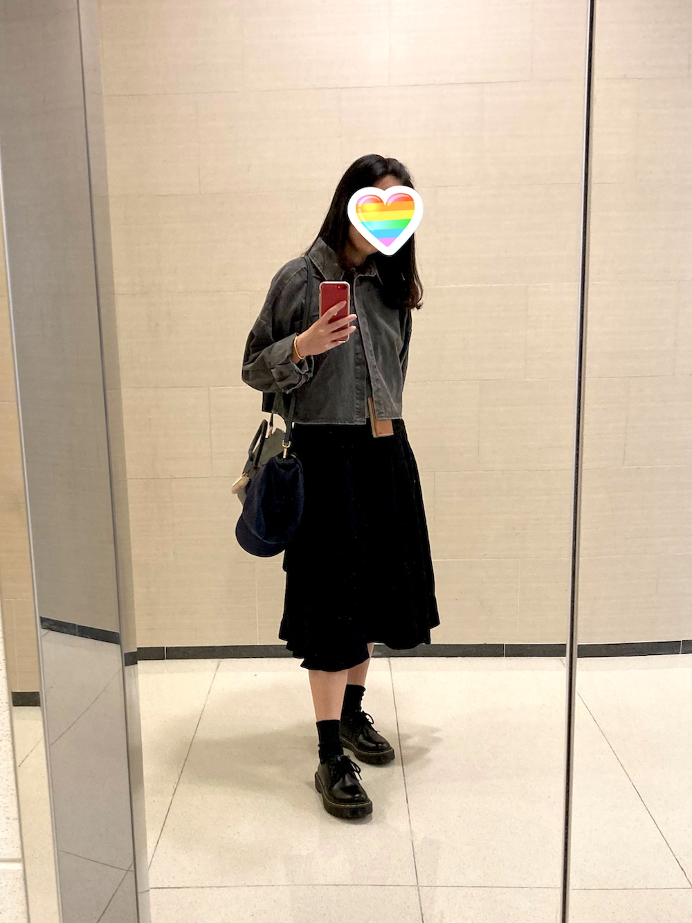 ブラック系のブーツ、グレー系のショルダーバッグ、ブラック系のデニムジャケットを着用したレディースの冬コーディネートの2枚目の写真