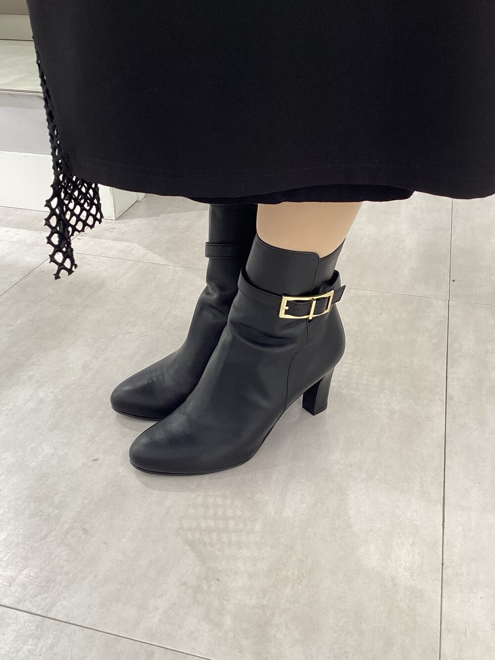 ブラック系のバッグ、ブラック系のブーツを着用したレディースの冬コーディネートの2枚目の写真