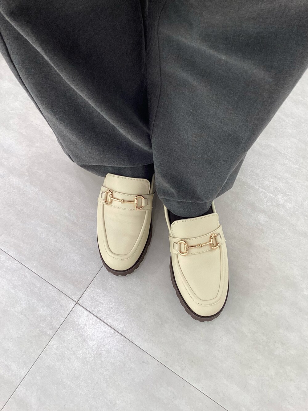 ホワイト系のローファーを着用したレディースの冬コーディネートの2枚目の写真