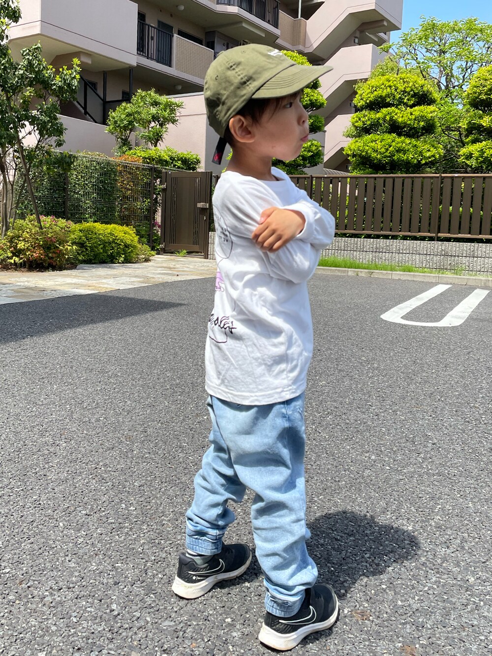 ホワイト系のTシャツ/カットソー、ブルー系のパンツ、ブラック系のスニーカーを着用したキッズの春コーディネートの2枚目の写真