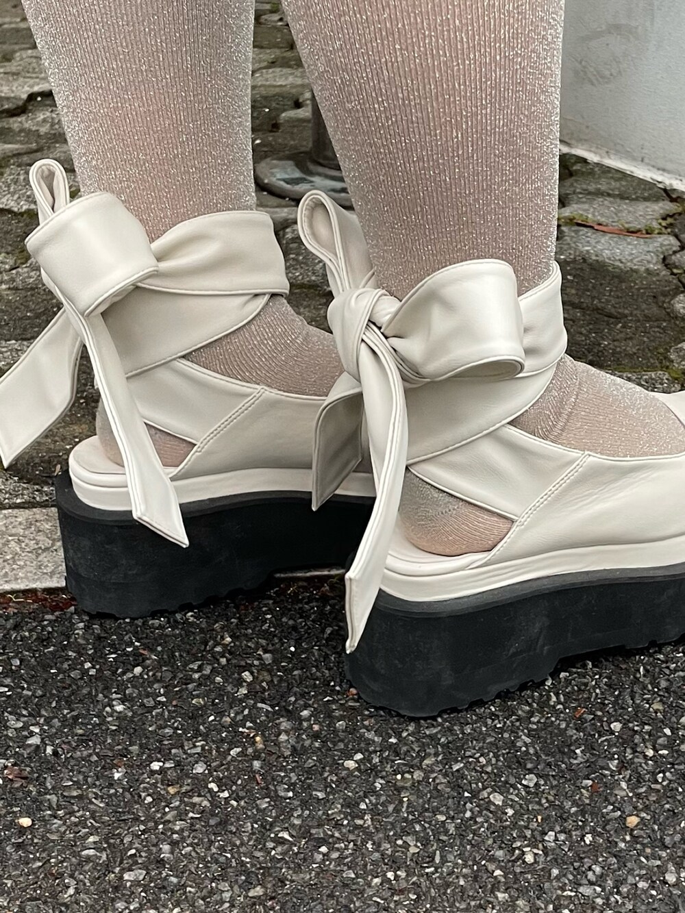 ブルー系のワンピース、ホワイト系のパンプスを着用したレディースの冬コーディネートの7枚目の写真