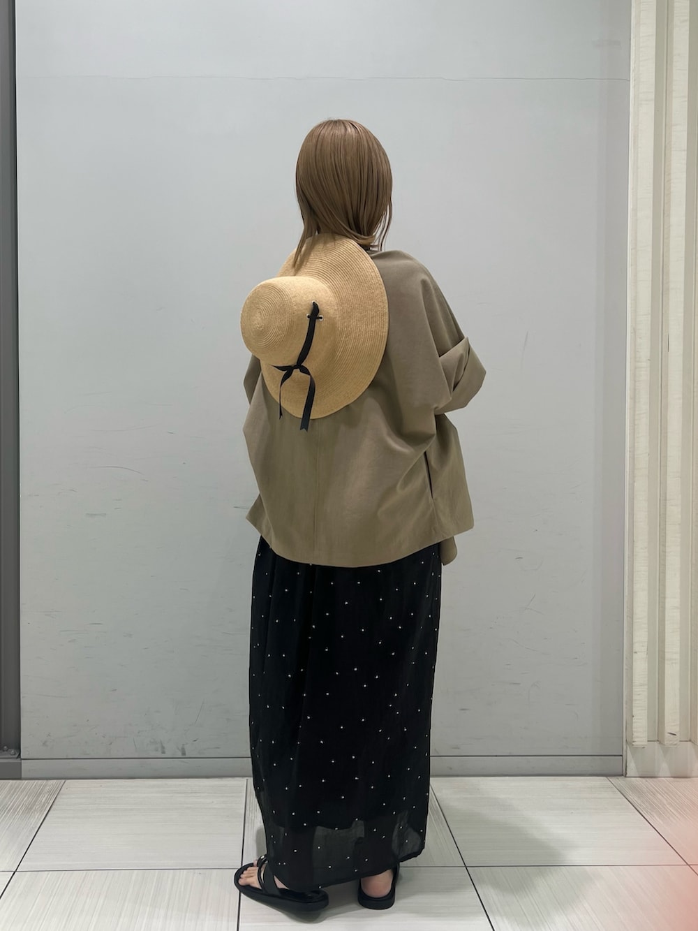 グレー系のテーラードジャケット、ブラック系のパンプス、ブラウン系のワンピースを着用したレディースの春コーディネートの7枚目の写真