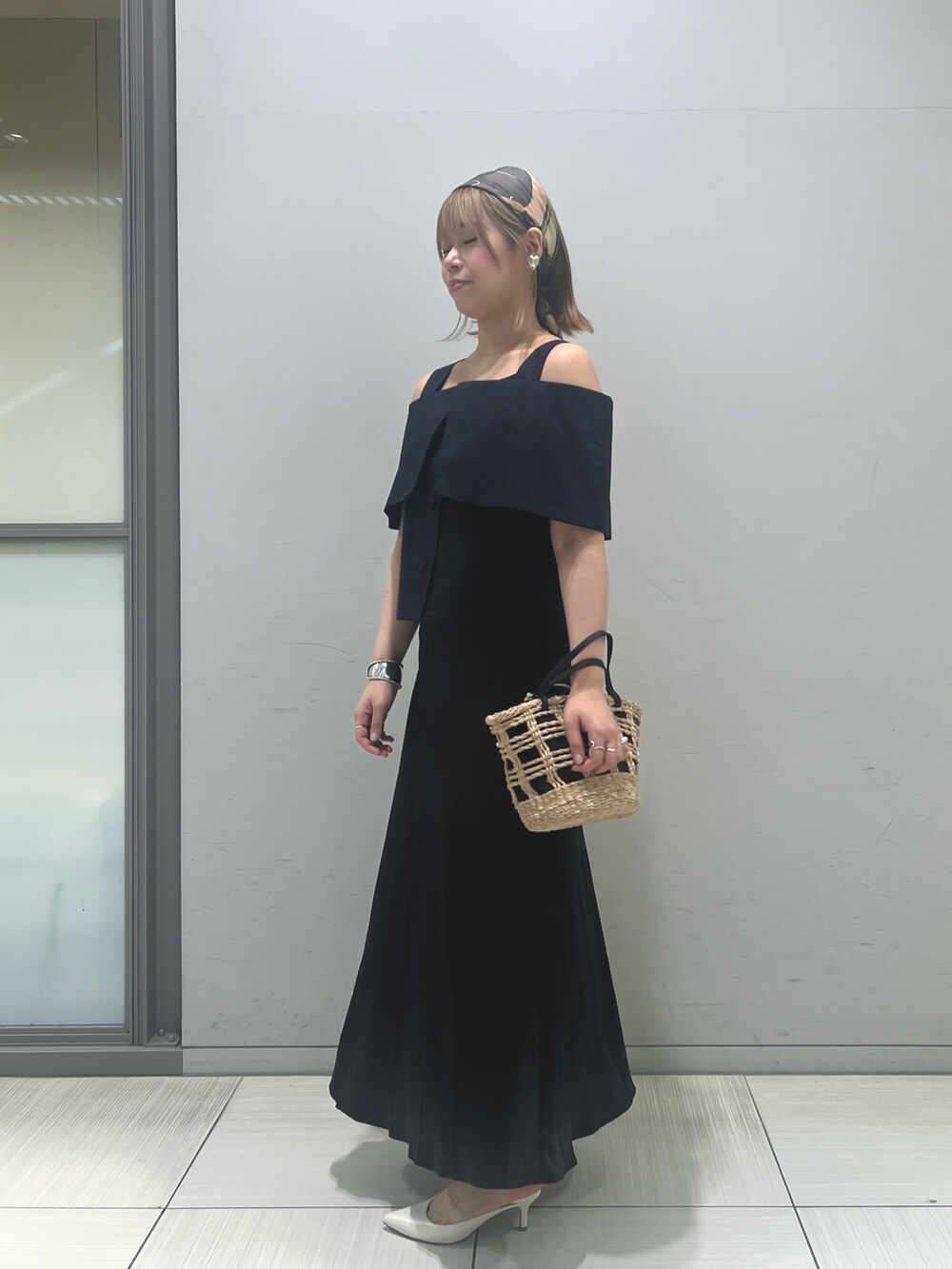 ベージュ系のかごバッグ、ブラック系のシャツ/ブラウス、ブラック系のスカートを着用したレディースの春コーディネートの2枚目の写真