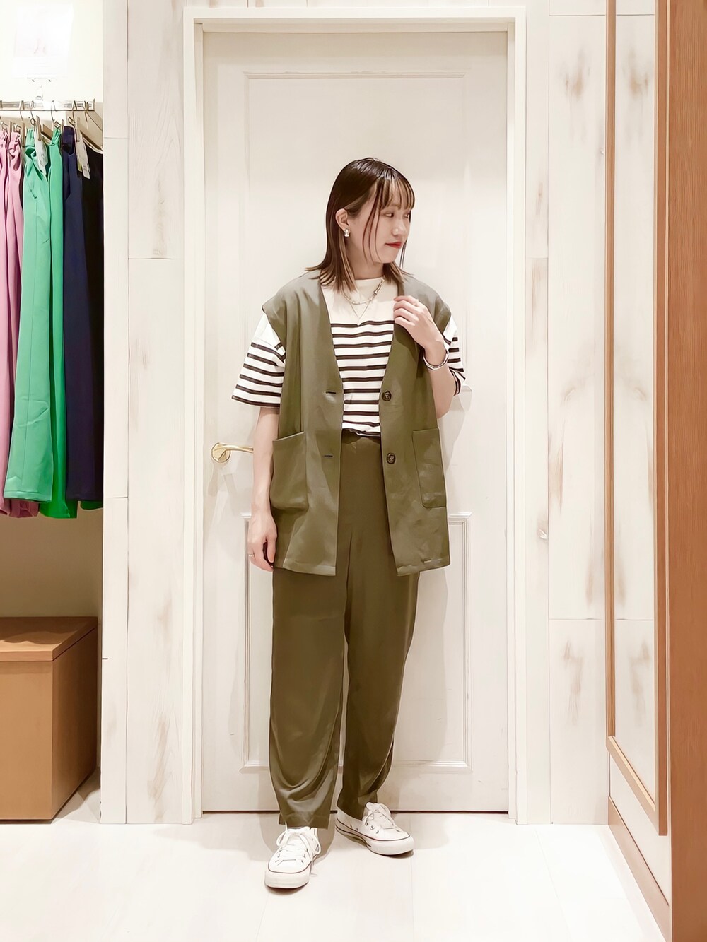 ホワイト系のTシャツ/カットソー、グレー系のベスト、グレー系のその他パンツを着用したレディースの春コーディネートの2枚目の写真