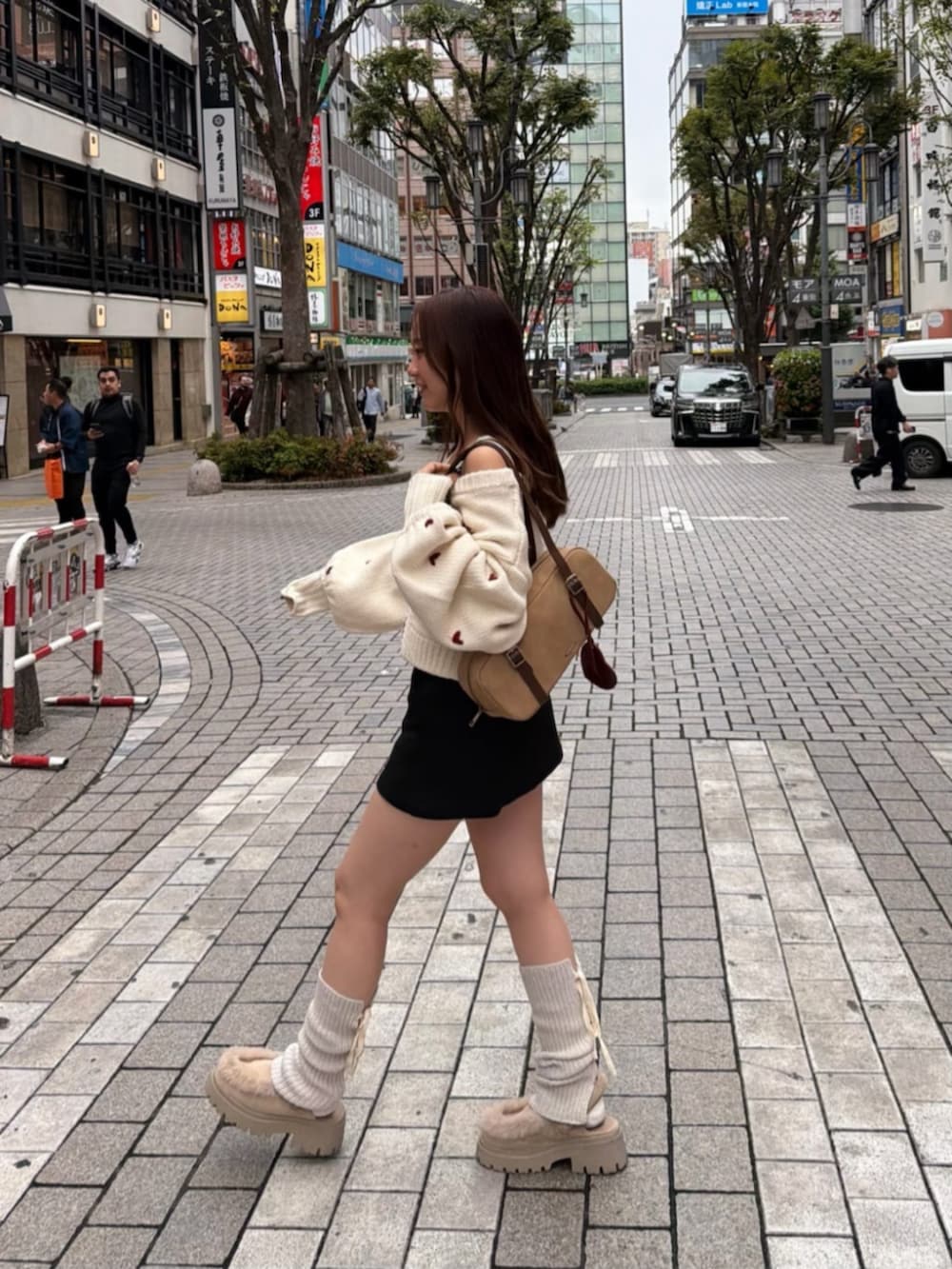 ブラック系のスカート、ホワイト系のカーディガン/ボレロを着用したレディースの秋コーディネートの2枚目の写真