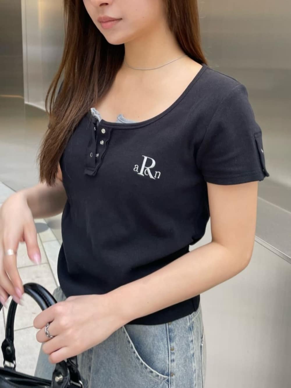 ブルー系のデニムパンツ、ブラック系のTシャツ/カットソーを着用したレディースの春コーディネートの2枚目の写真