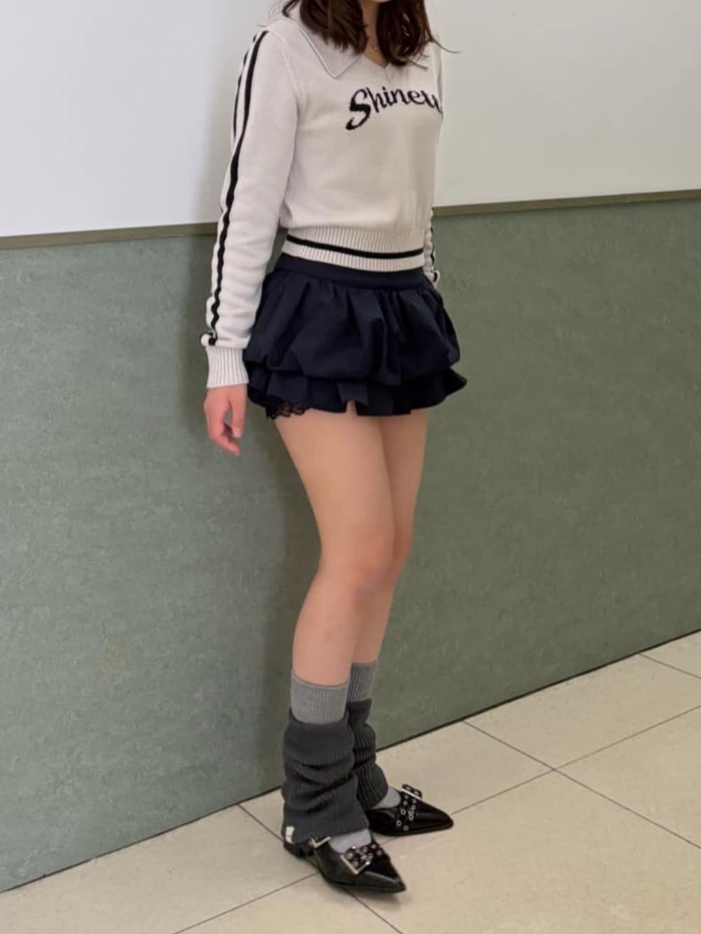 ホワイト系のニット/セーター、グレー系のレッグウォーマーを着用したレディースの冬コーディネートの2枚目の写真