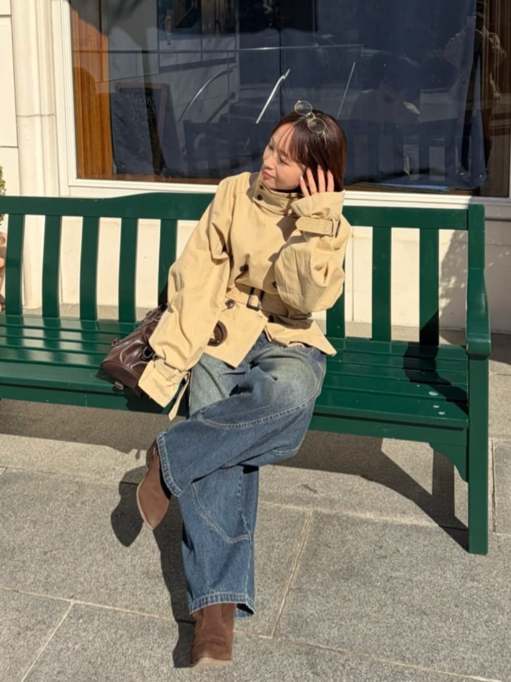 ベージュ系のトレンチコートを着用したレディースの冬コーディネートの3枚目の写真