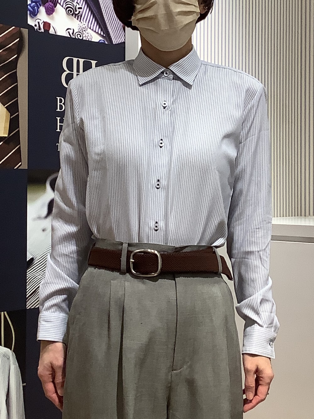 ブルー系のビジネスシャツを着用したレディースの春コーディネートの2枚目の写真