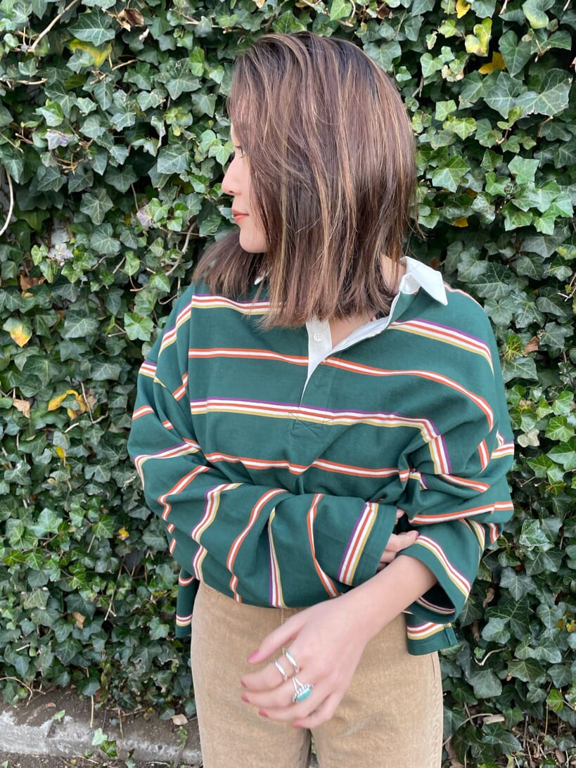 ベージュ系のデニムパンツ、グリーン系のTシャツ/カットソーを着用したレディースの冬コーディネートの6枚目の写真